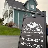 MW Roofing and General Contracting lawn sign in front of a blue-green house, showing the company logo and phone numbers